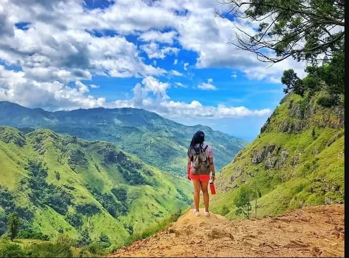 A traveller looking out over the green hills near Ella, Sri Lanka